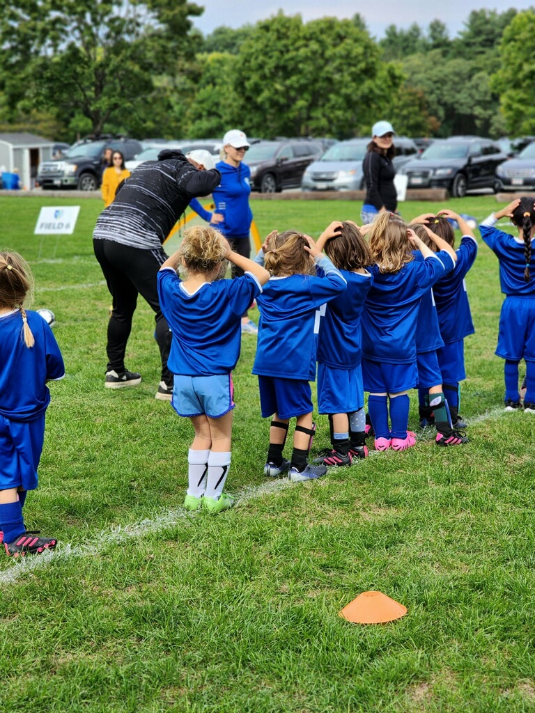 Image of prek/k/1st grade program doing pregame exercises
