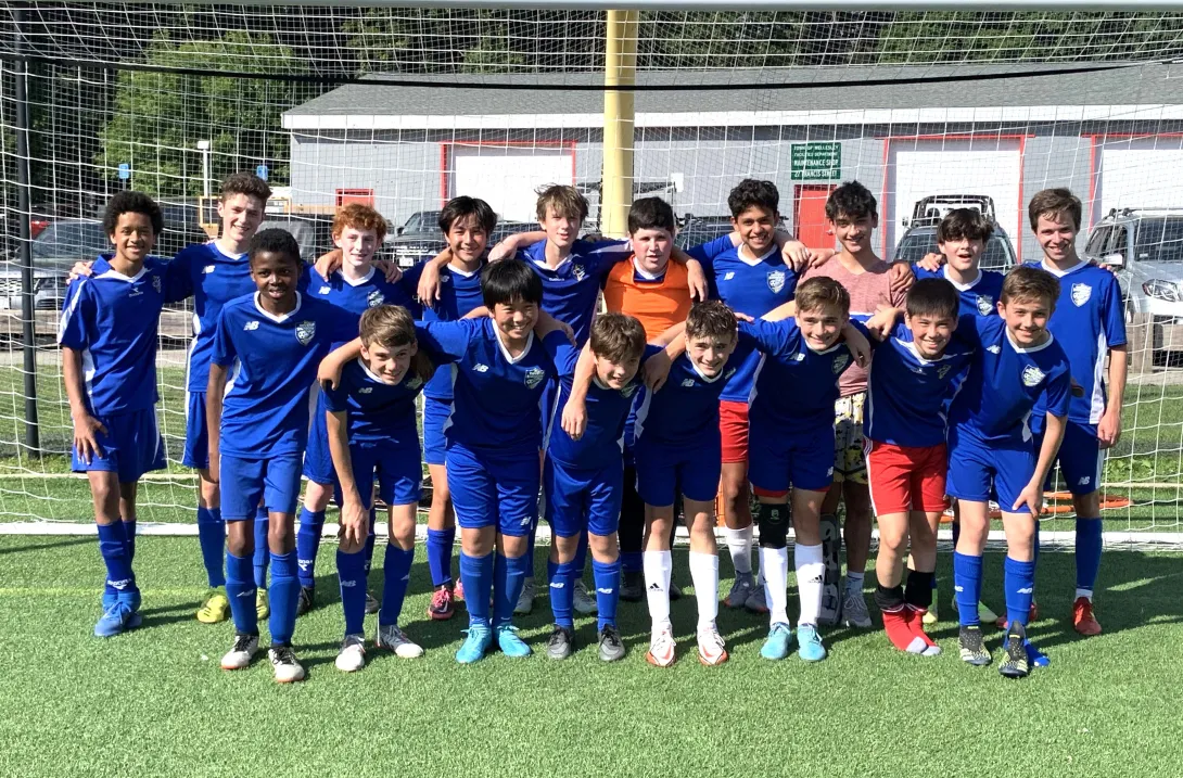 Boys 7-8 grade lightning team posing for a team photo in front of the goal